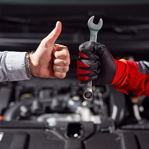 Mechanic and client giving thumbs up